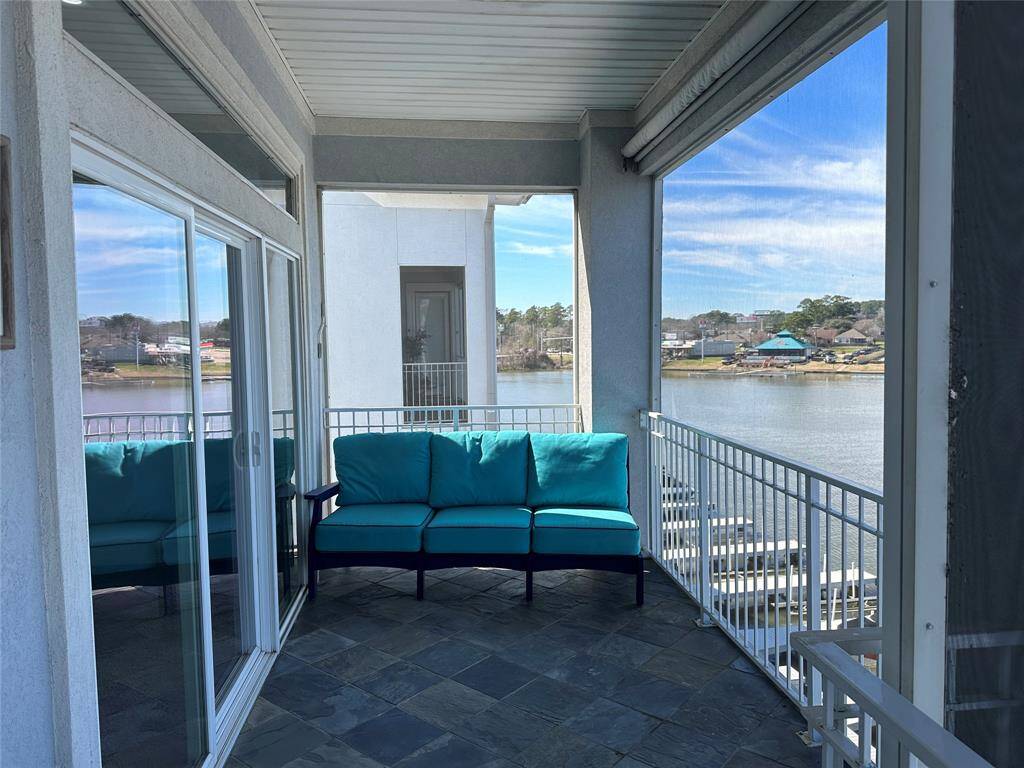 View of the screened in balcony/patio with slate floors and view of the lake