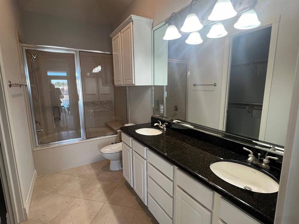 Very large primary bathroom with double sinks, granite counter & huge garden tub