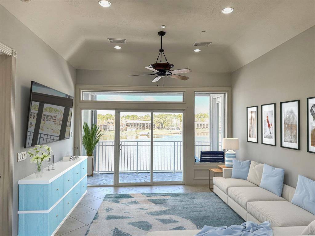 Large family room looking out into the lake. virtual staged