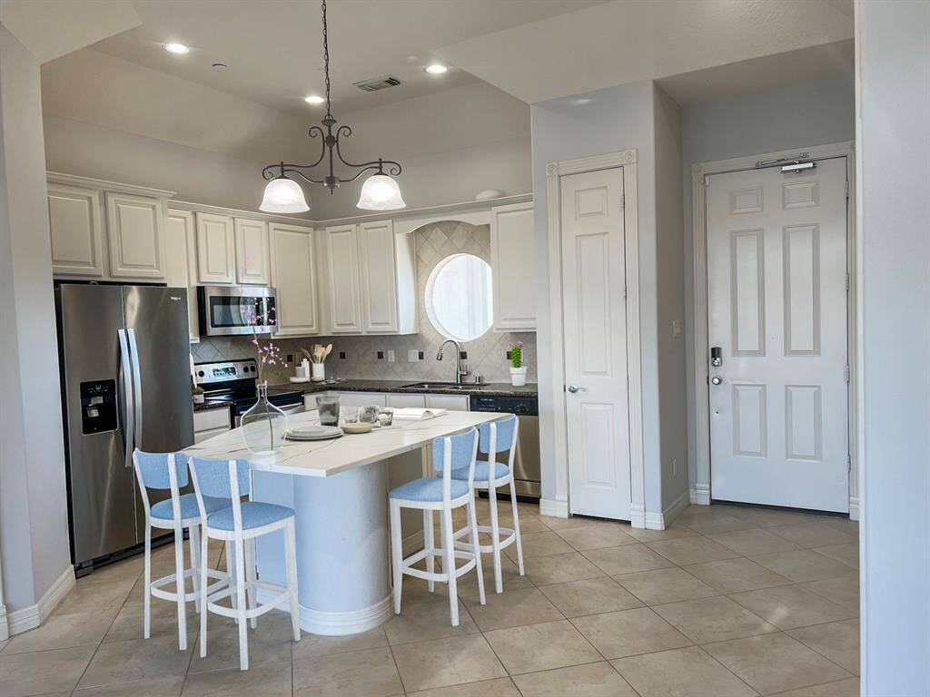 Kitchen with all stainless steel appliances & pantry. virtual staged
