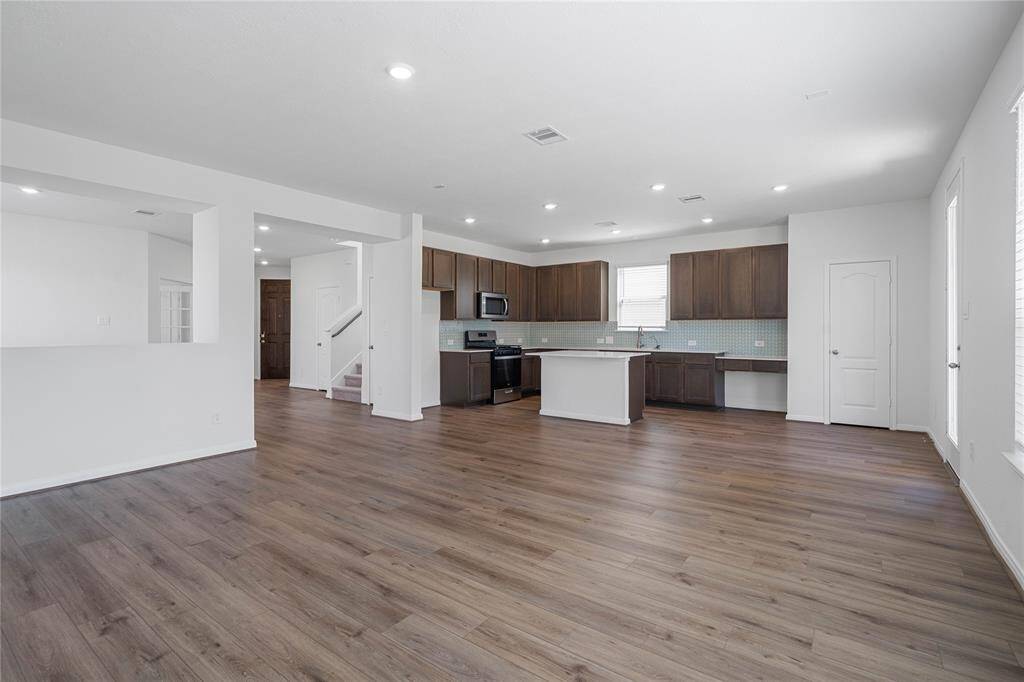 A beautiful view of this spacious open concept family room and kitchen!