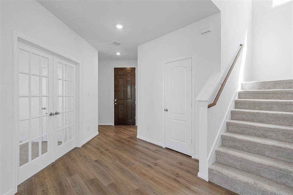 Welcome inside 22415 Hawberry Blossom! Not only is the entryway bright, but it leads you inside a spacious home. The Den is highlighted here with the double French doors and the staircase leading to the second floor!