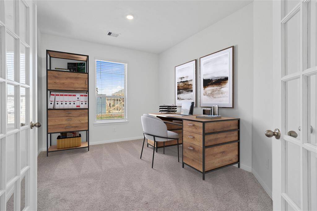Quietly nestled in the home is the handsome den. Featuring the beautiful double French doors, high ceilings, recessed lighting, large window with privacy blinds, and neutral paint.