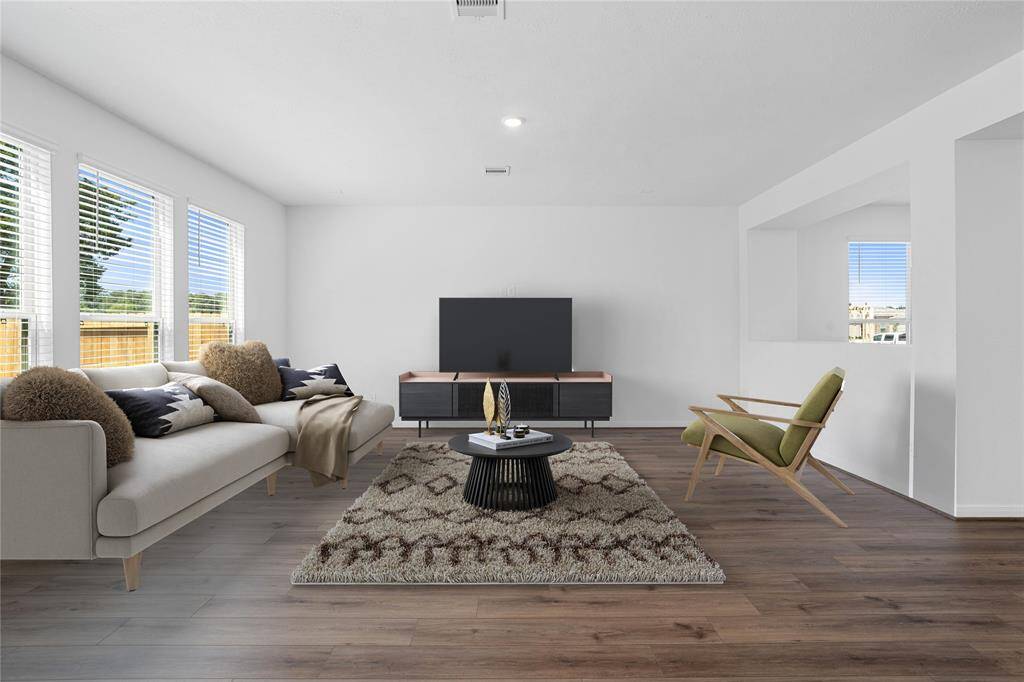 Gather the family and guests together in your lovely family room! Featuring high ceilings, recessed lighting, custom paint, gorgeous vinyl plank flooring, and large windows with blinds that provide plenty of natural lighting throughout the day!