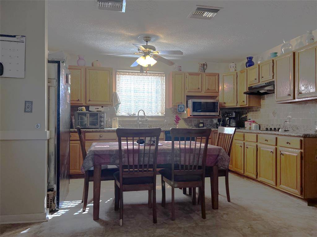 View of dining area and kitchen from the living room.
