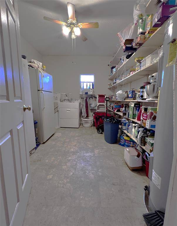 This utility room is large enough for the washer, dryer, freezer, and extra fridge. Oh, and shelving for extra pantry use or storage.