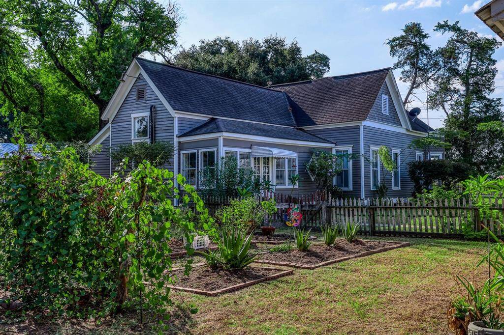 This one story home has a well-maintained garden and picket fence, offering a cozy and inviting atmosphere amidst lush greenery. There is a separate well for irrigation.This entrance leads into the sunroom.