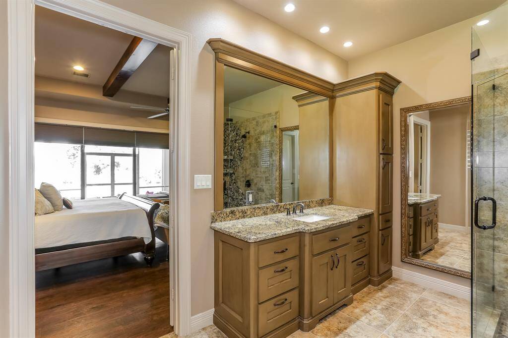 Primary bath offers his and her vanity with built in cabinets