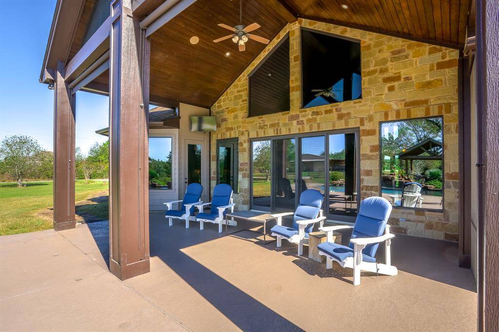 Beautiful oversized porch with custom shades to lower as needed and custom screen over the truss