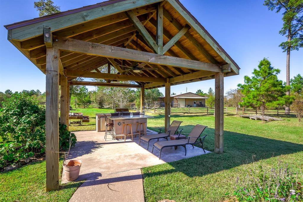 Escape to your outdoor patio, top of the line Paradise Grill and bar with lights and fan to stay cool in the summer