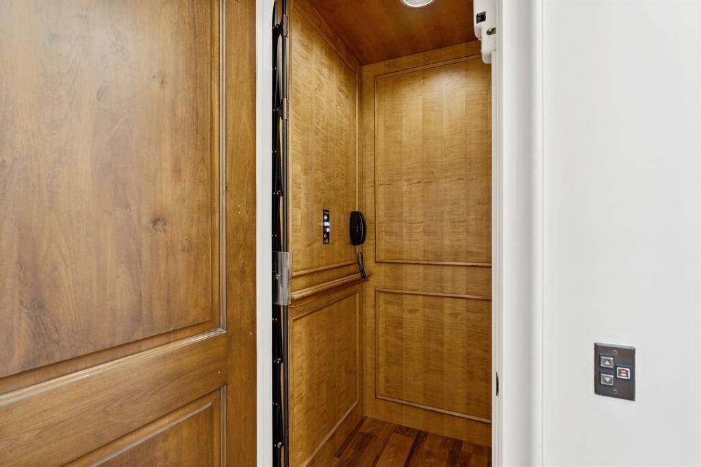 [Elevator] Wood paneled with access to the second floor.