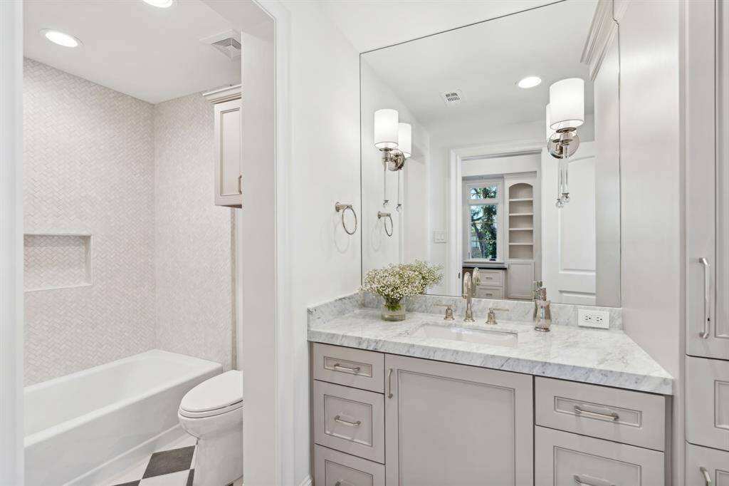 [En Suite Bath 1] Remodeled bath with Anne Sacks herringbone tile in the tub/shower combo and checker board floor tile.