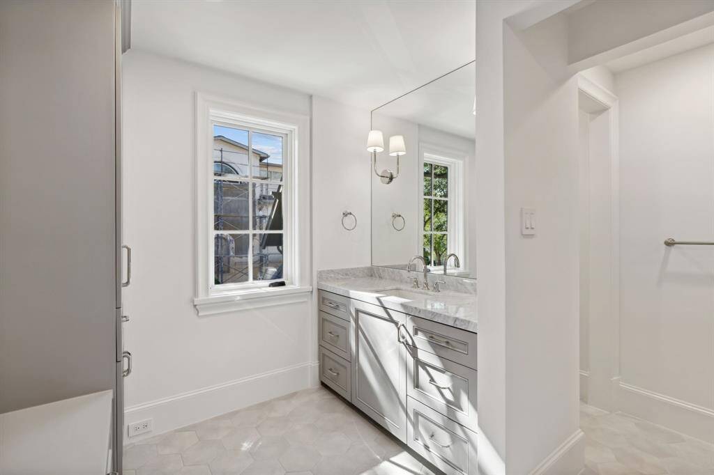 [En Suite Bath 2] Spacious bathroom with bench seat, walk in closet with built ins and separate water closet