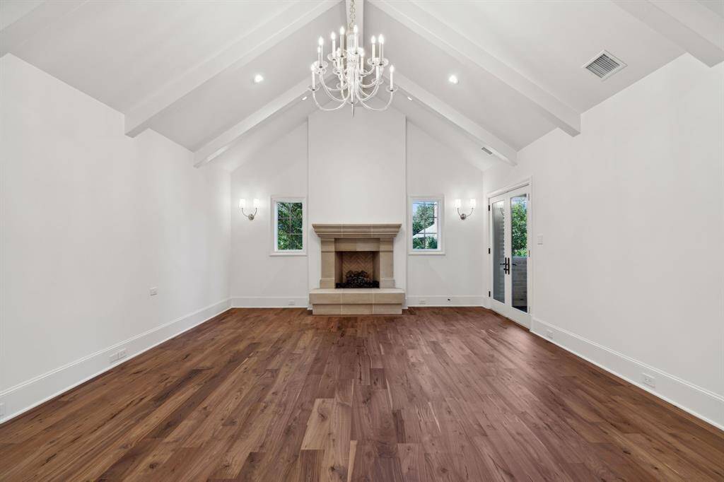 [Primary Bedroom] Vaulted ceiling, Visual Comfort chandelier, private balcony and gas fireplace