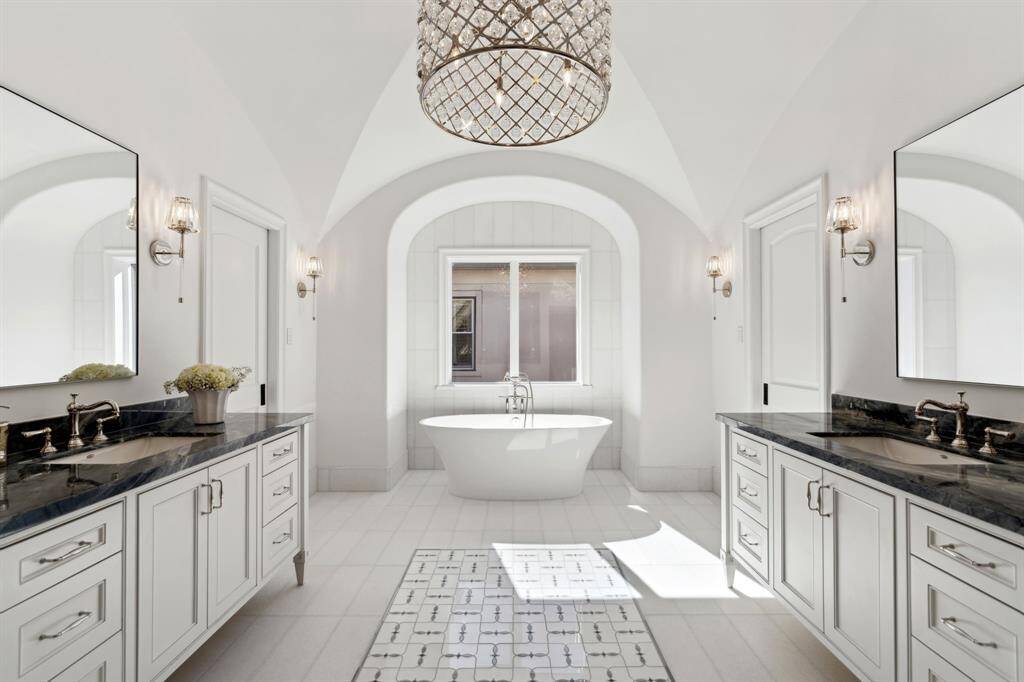 [Primary Bath] Gorgeous retreat!  Mable bath floors and counters, soaking tub, separate shower and separate water closet. double vanities and gorgeous chandelier