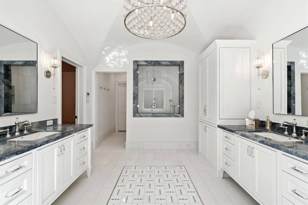 [Primary Bath] Separate shower, his + her's oeversized walkin closets with built ins.