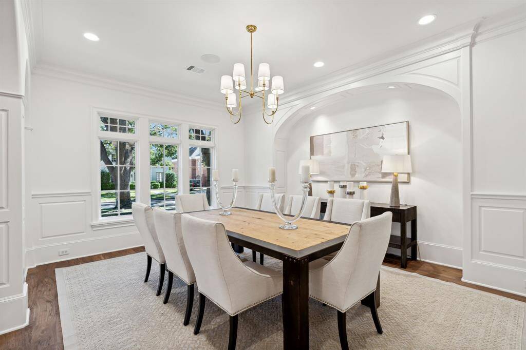 [Entry] The lovely wood front door opening to this charming entry foyer with arched high ceilings and walnut wood flooring.