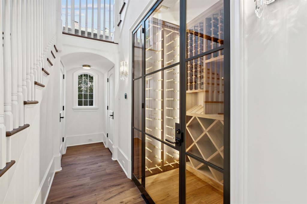 Hallway to wine room, half bath and large storage closet