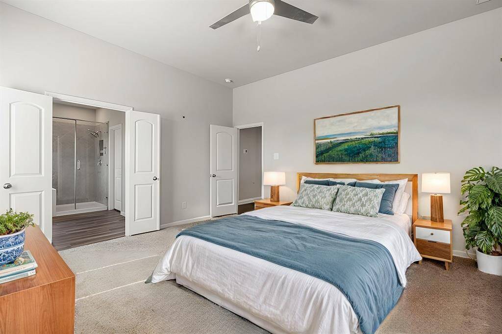 Primary bedroom with en-suite bathroom features double doors for privacy into the bathroom.