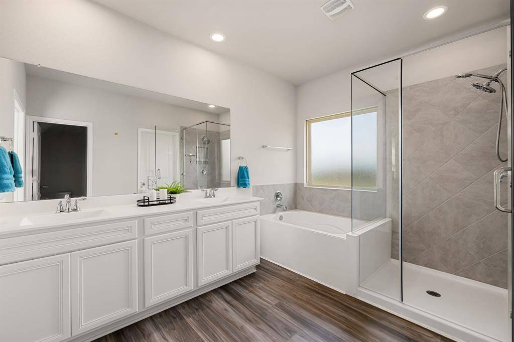 Primary en-suite features double sinks, soaker tub and standalone shower.