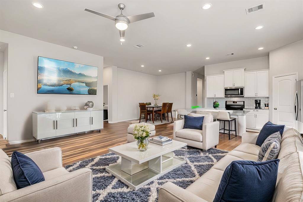 Living room is open to the kitchen and the formal/casual dining space.