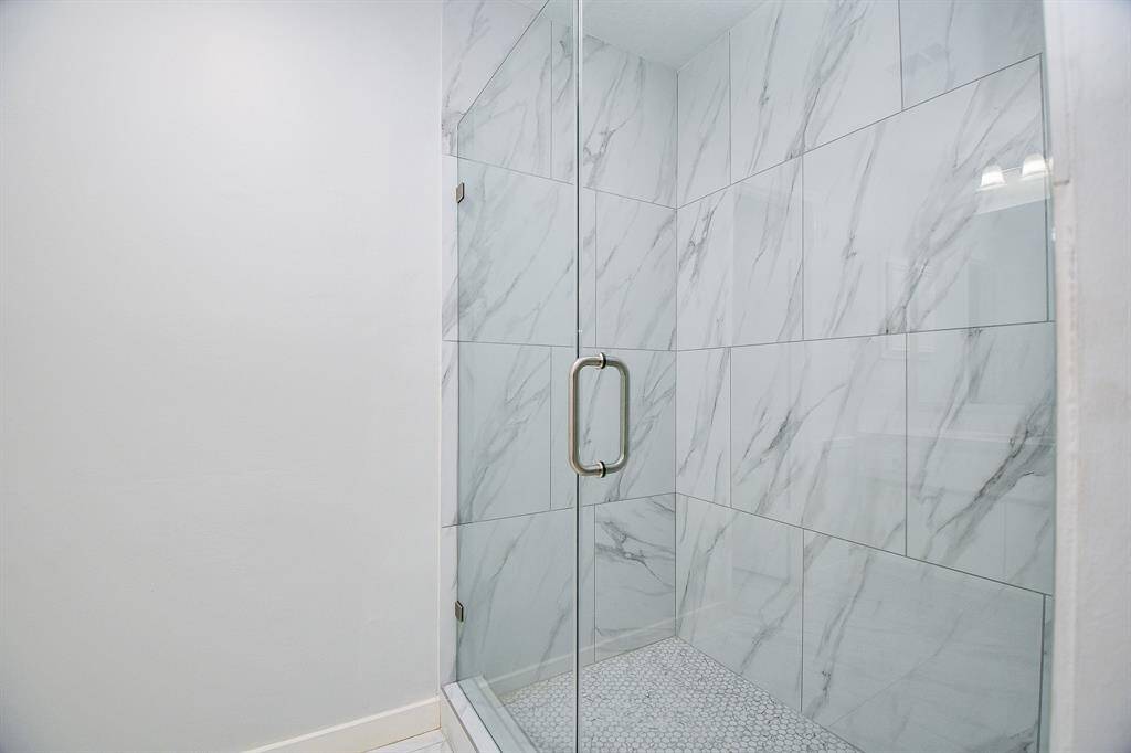 New walk in shower with glass enclosure and door