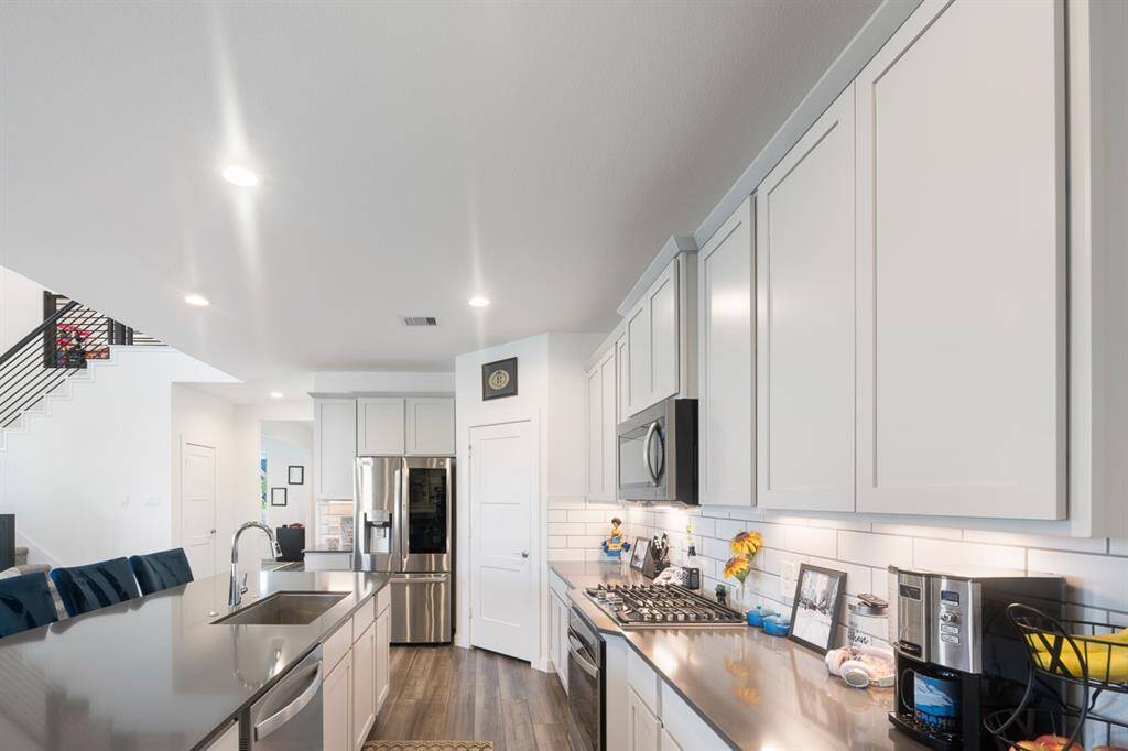 Another view of this great Kitchen! Stainless steel cooking appliances, sink and dishwasher - definitely a sleek kitchen!