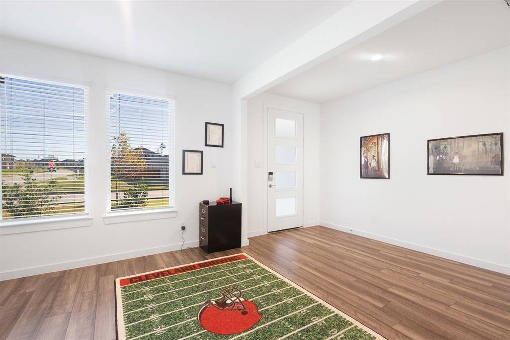Spacious entry. This home offers vinyl plank flooring throughout most of the house except carpet in the bedrooms, game room and media room.