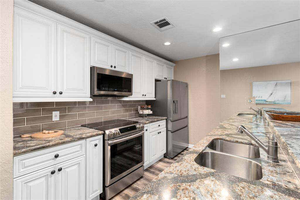 GORGEOUS KITCHEN WITH TOP-OF-THE-LINE GRANITE! ALL APPLIANCES RECENTLY UPDATED! WASHER/DRYER, REFRIGERATOR & WINE FRIG STAY! ALL FURNISHINGS INCLUDED!