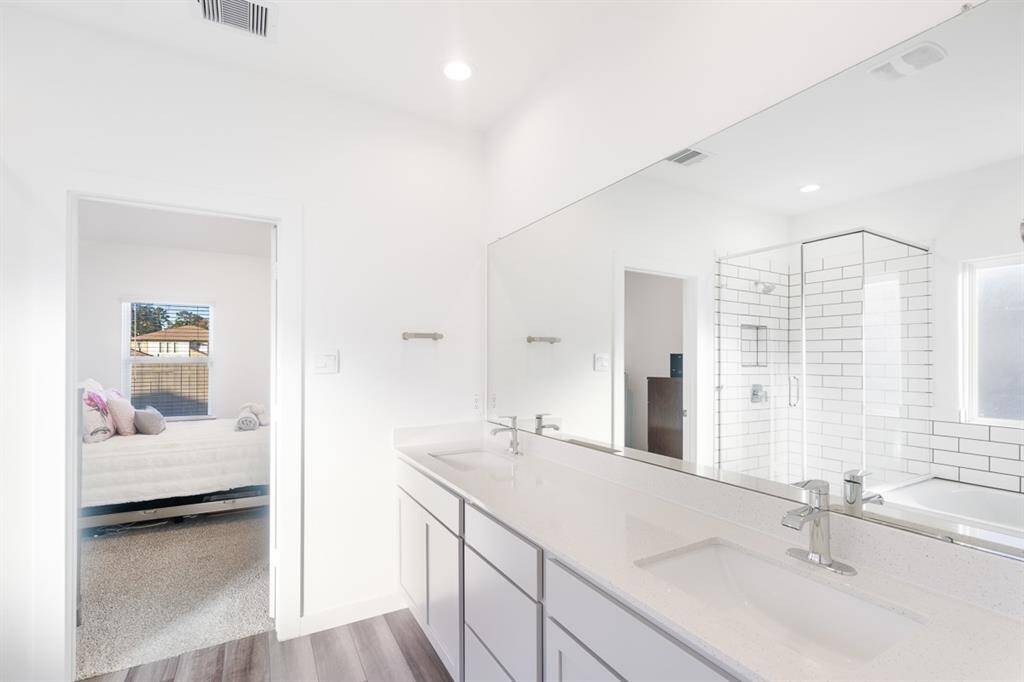Now for the primary baths. Long vanity double sinks and ample counter topa and cabinet space. You access a large, walk-in closet thru this bath.