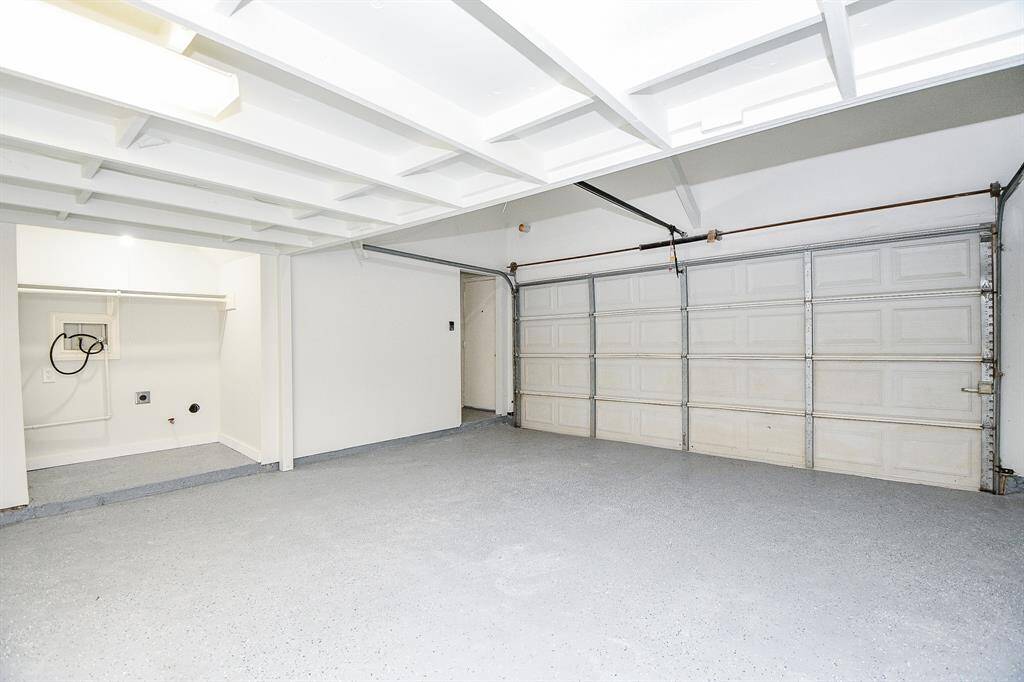 Recently painted Garage with overhead storage and epoxy floor paint