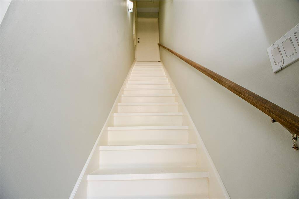 Rear stairway into garage with exterior door