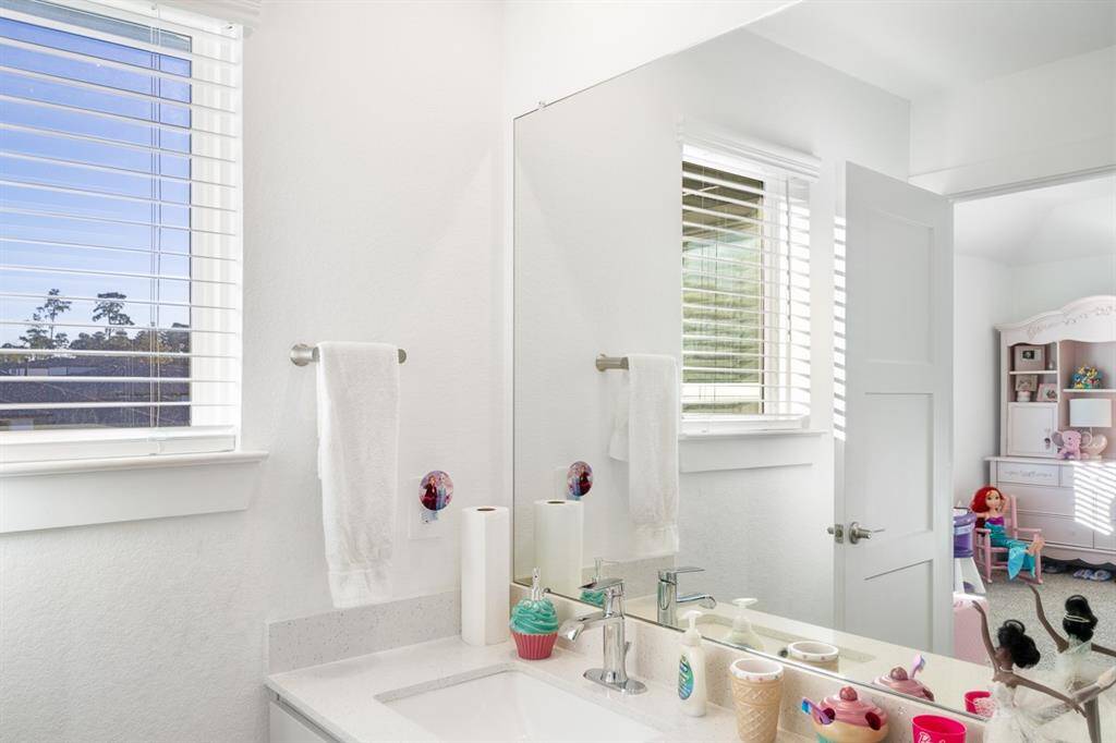 Here is the secondary bedroom's en-suite bath. The baths is spacious with a tub and shower combination and tile surround.