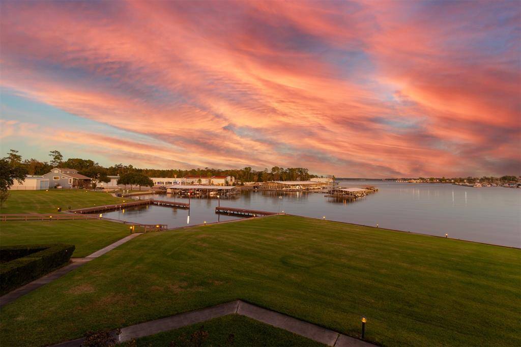 LUSH MANICURED LAWN AREA! SHELTERED DOCKING AREA FOR YOUR BOAT OR JET SKI! GORGEOUS SUNSET VIEW OF LAKE CONROE!