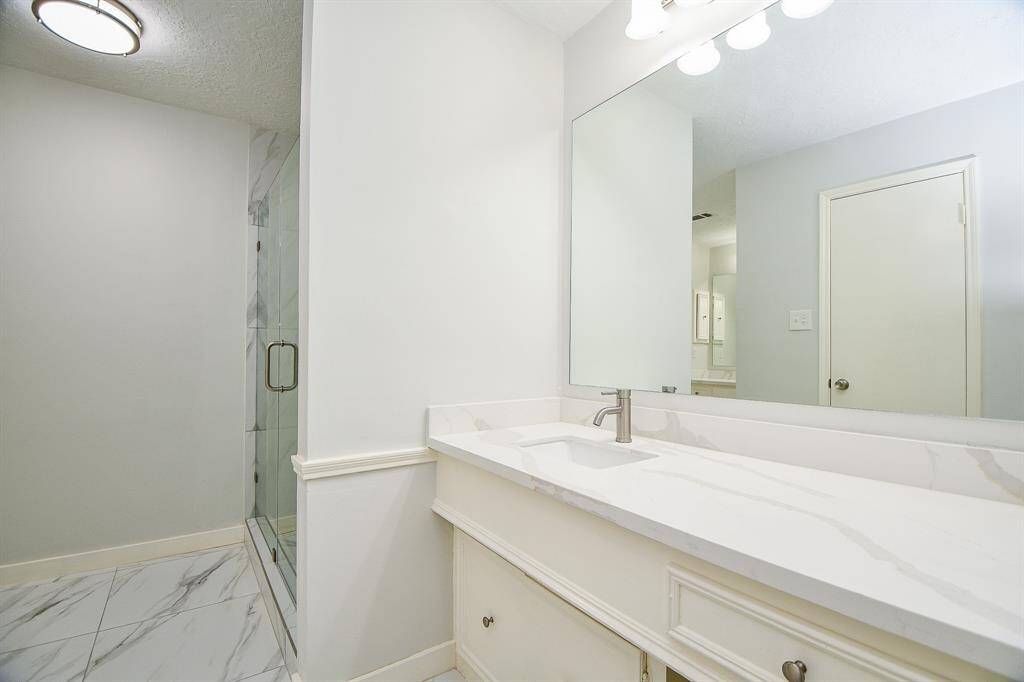 Remodeled Primary Bath with double quartz vanities new walk in shower on right