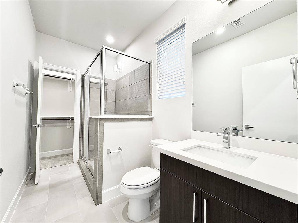First floor - bathroom, standup shower, and walk-in closet