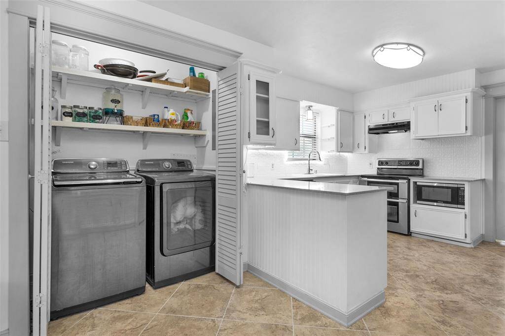 Laundry area centrally located and maximized behind double doors.