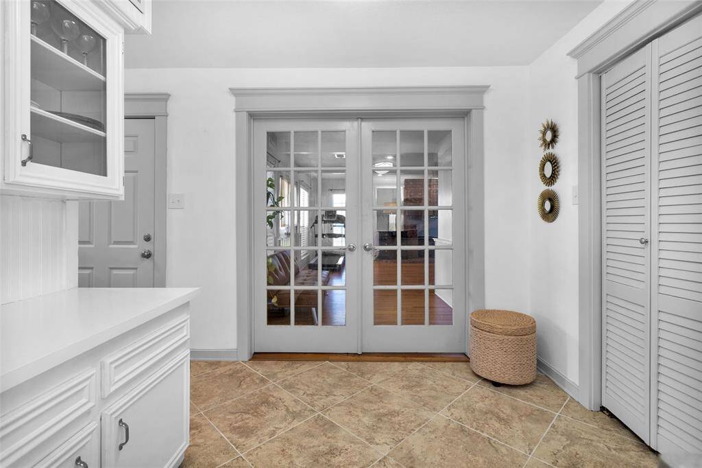 Just beyond the coffee bar, double french doors lead you into the primary suite.
