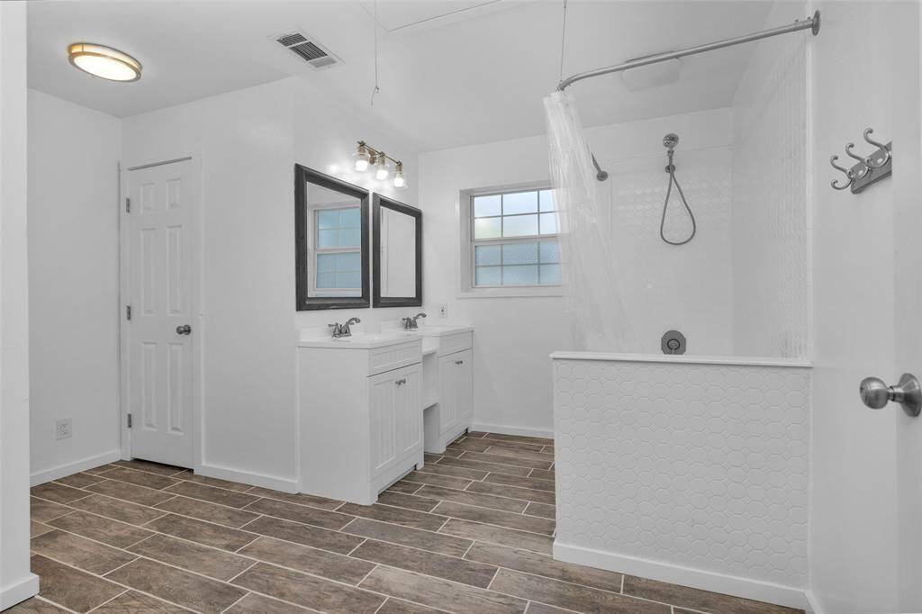 The upstairs bathroom has plenty of storage and modern convenineces.