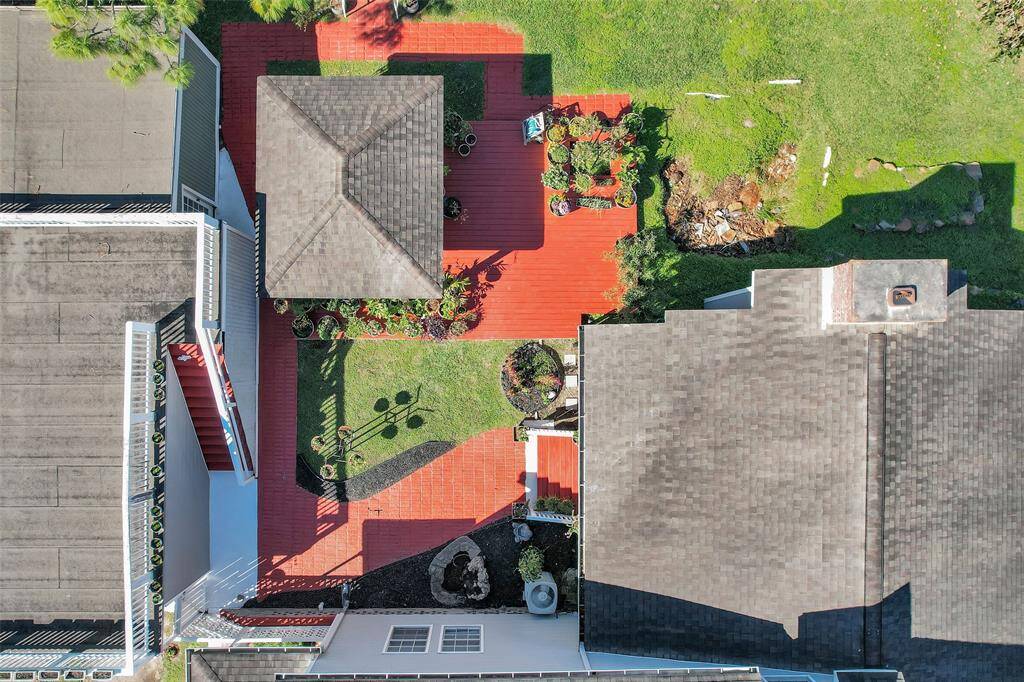 This aerial view shows the lovely courtyard created between the house, garage, and large covered deck.