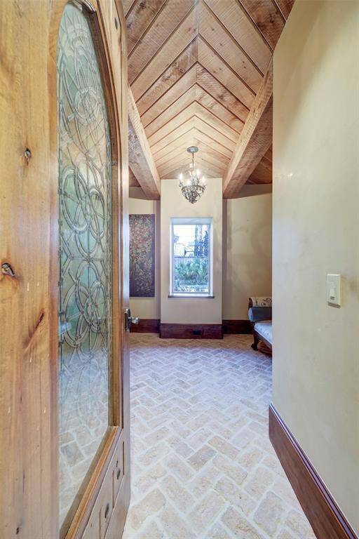 The reflection room is a serene sanctuary, featuring charming brick flooring, a rustic timber-beamed ceiling, and a stunning stained-glass door. A centrally placed window offers a peaceful view of the koi pond, enhancing the room’s tranquil ambiance.