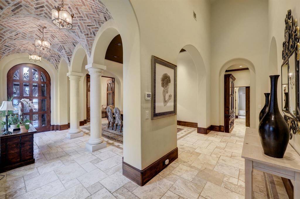 With brick barreled ceilings, intimate archways, and an array of rooms waiting to be explored, the home’s dining area is a true highlight. It features a sophisticated wine room and seamlessly connects to the elegant bar, perfect for both entertaining and relaxation.