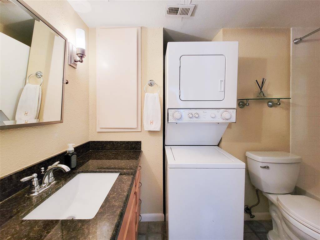 The stacked washer and dryer stays with the condo.