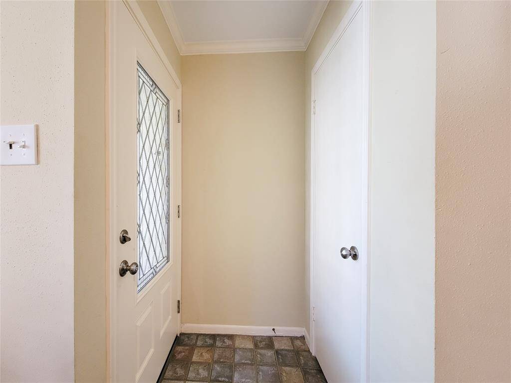 The light-filled entry has a tile floor and coat storage closet.