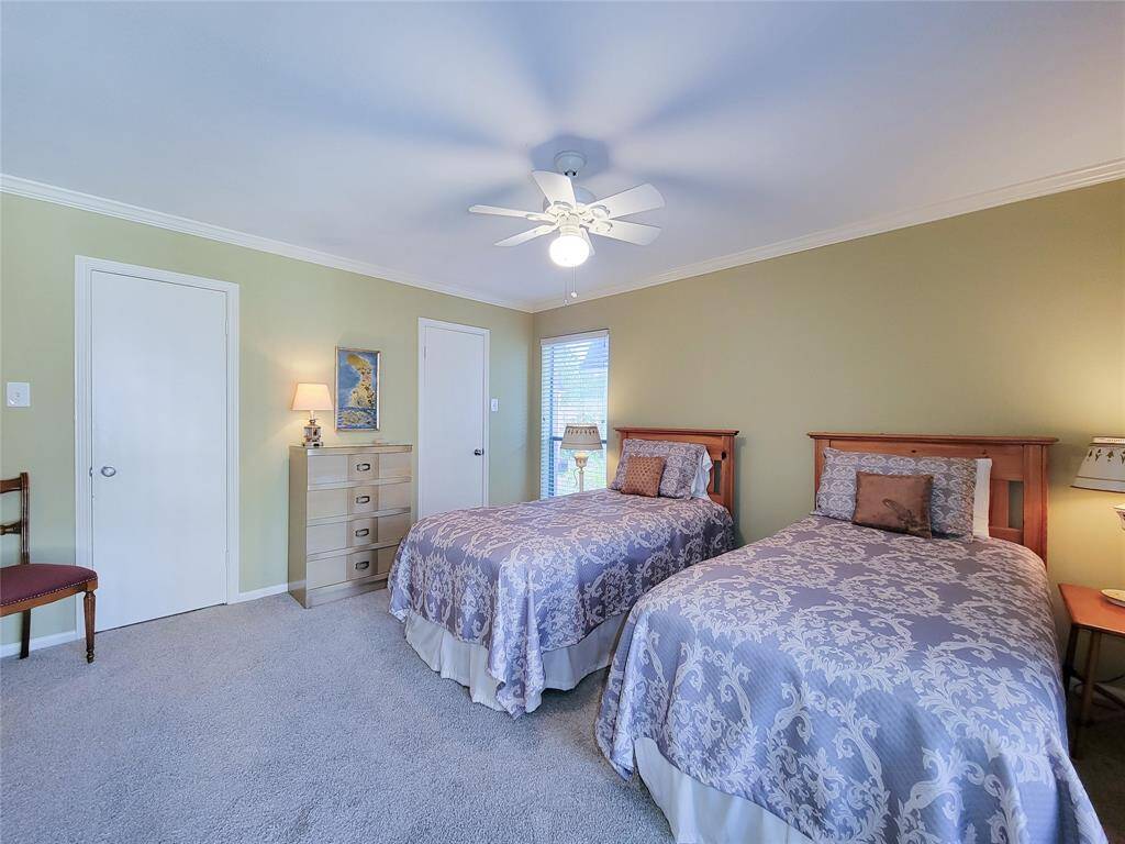 The 14' x 13' bedroom has a large walk-in closet with two doors, windows and a ceiling fan.