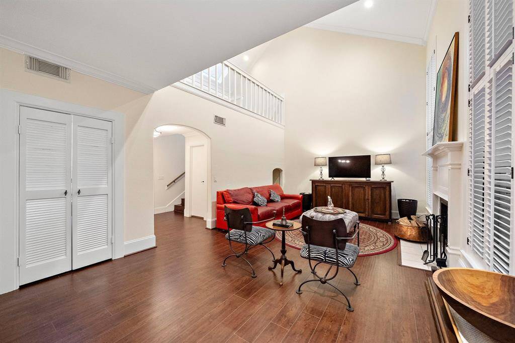 Expansive and airy, this living space offers a serene atmosphere for large and intimate gatherings alike—anchored by a gorgeous fireplace.