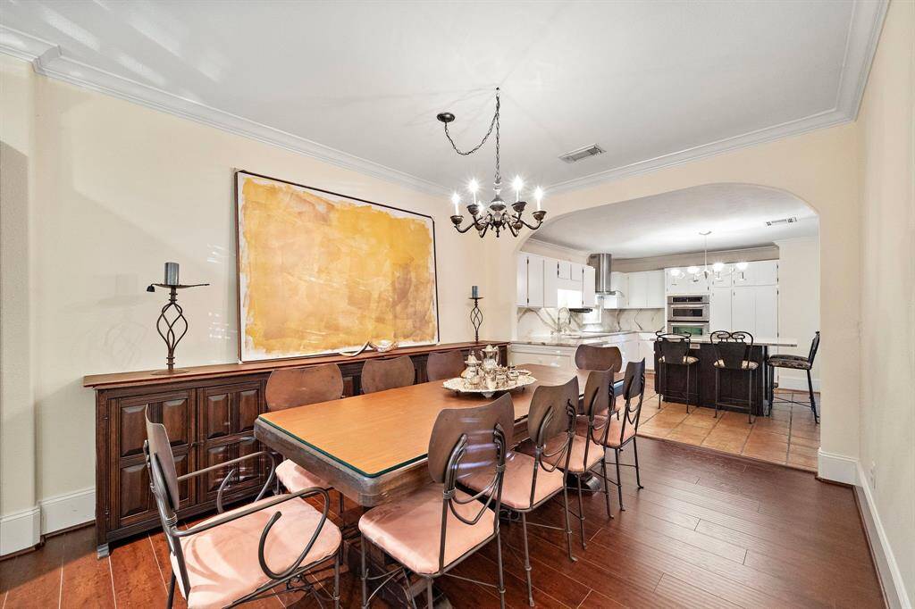 With its seamless flow to the kitchen and striking wood tones, the dining room serves as a centerpiece for both relaxed meals and formal occasions.