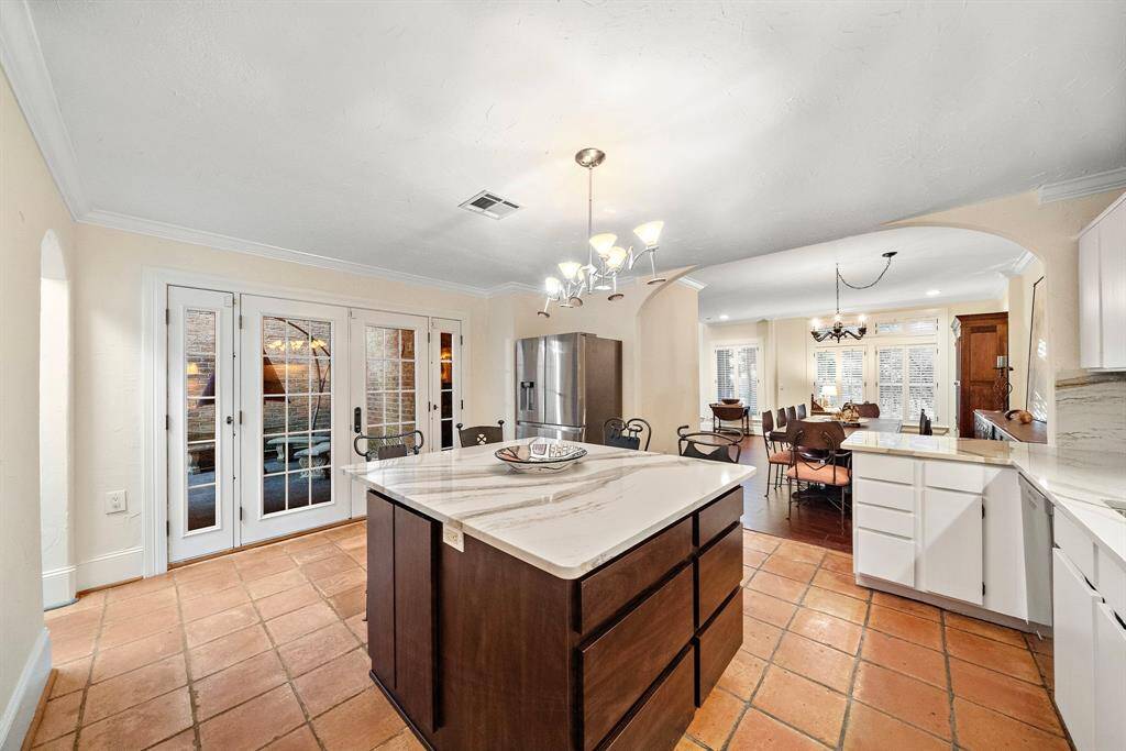 French doors open to the patio, offering seamless indoor-outdoor flow and enhancing the kitchen's versatility.