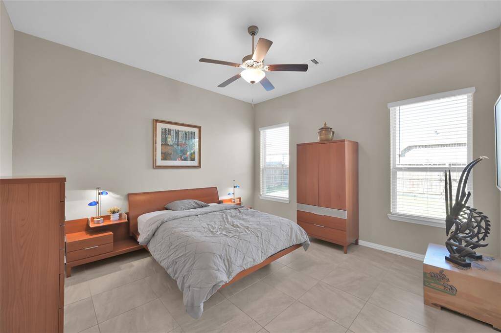 Large bright primary suite, continuing the tile thoughout and opening into the double split closets and split primary bath