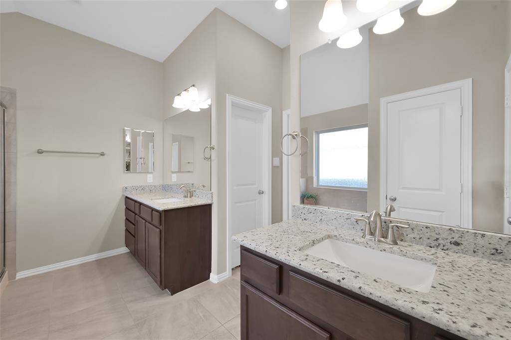 Separate sinks to minimize those partner clutter disagreements.  The door pictured is one of the closets.  There is another walk in closet directly opposite as well